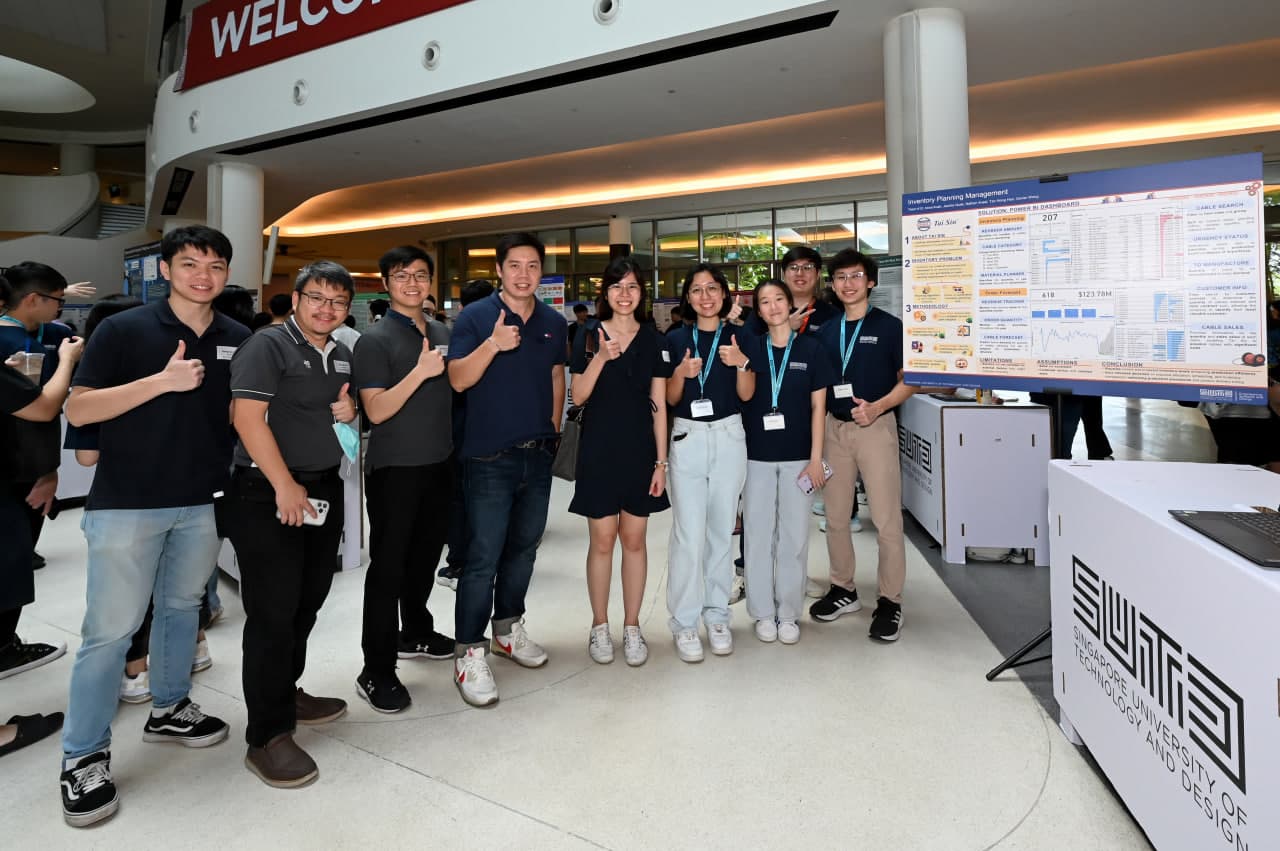 Project team and mentors presenting the inventory planning poster at the SUTD showcase